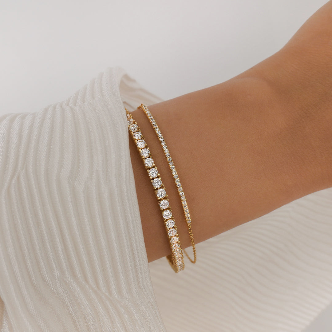 The Tennis Bracelet Gold with Zirconia Stone Settings layered with Layla Bracelet