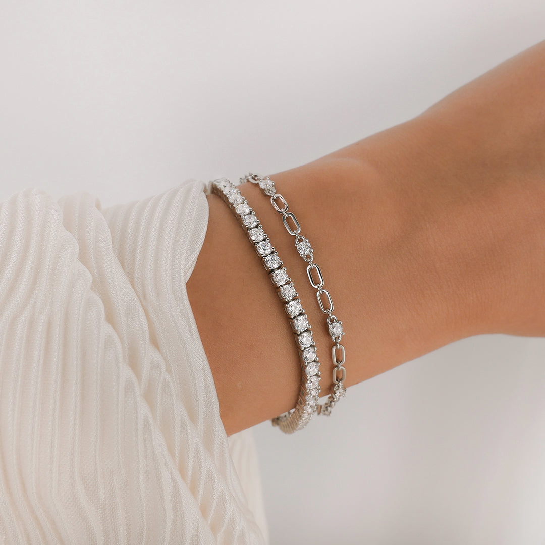 The Tennis Bracelet Silver with Zirconia Stone Settings layered with Jacinta Bracelet