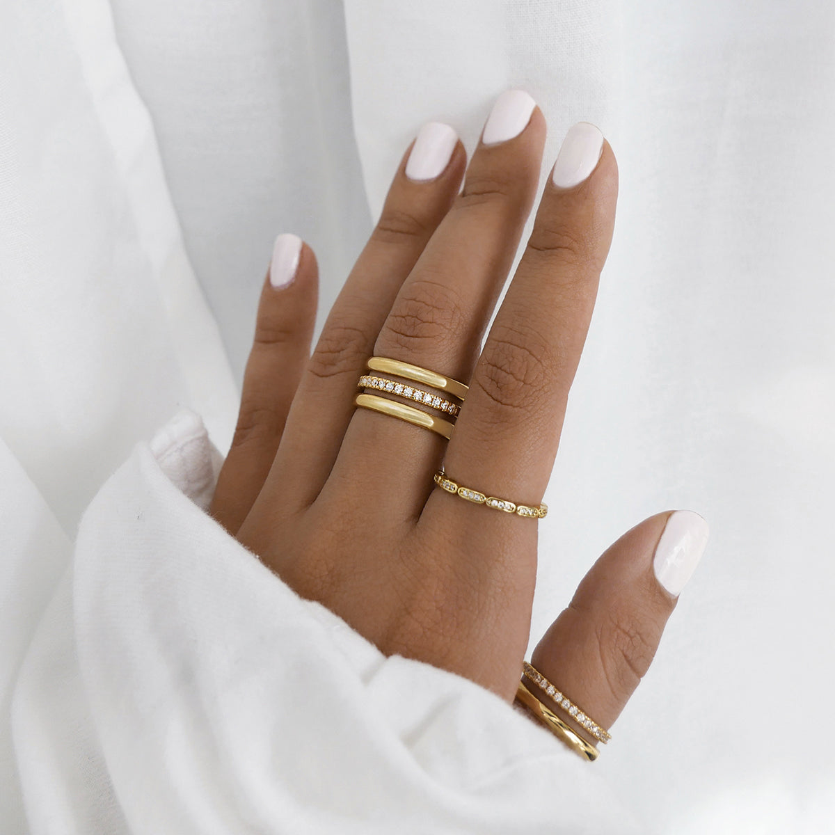 Multiple rings stacked in gold with stones